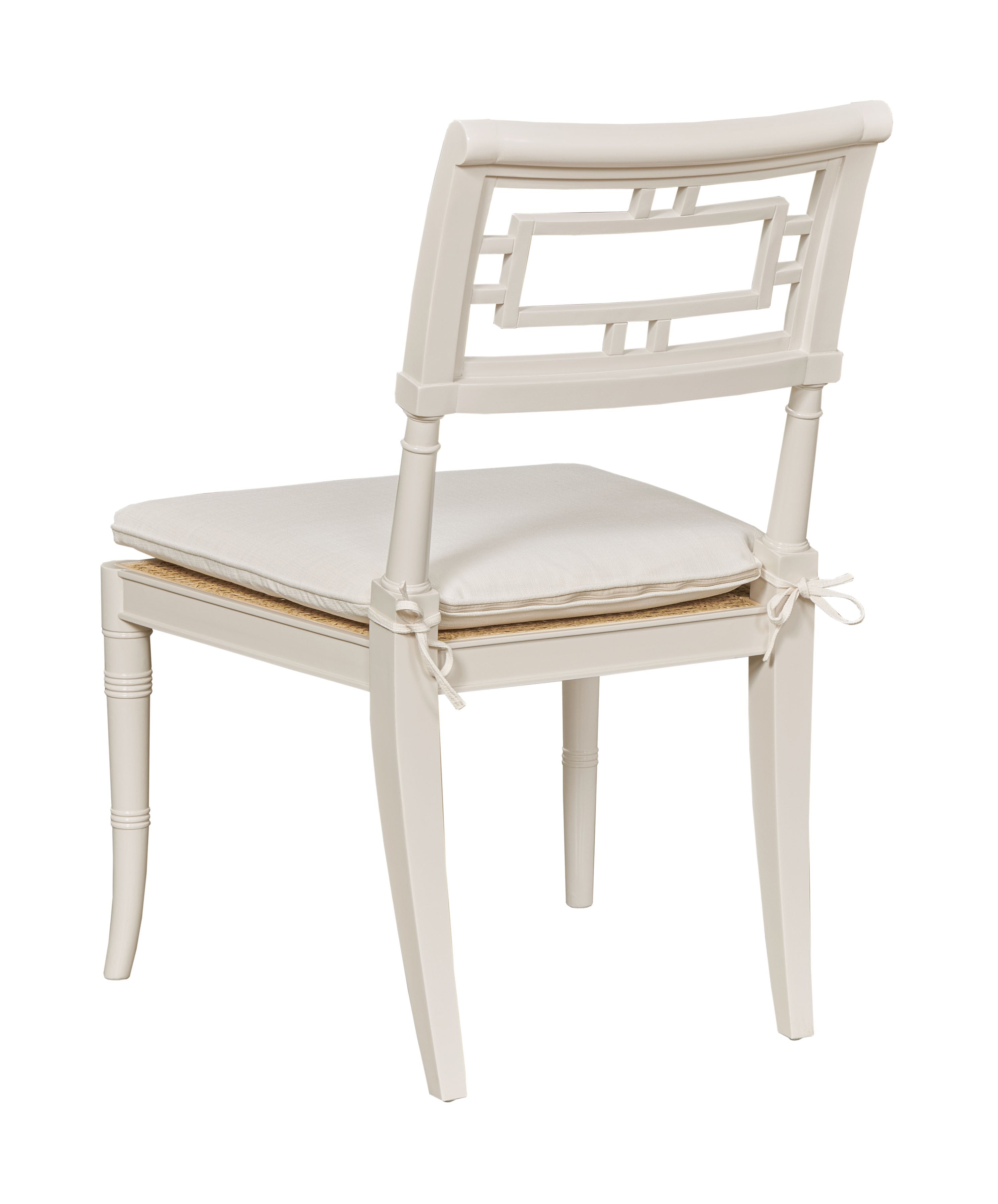 White chair with a cushion on a white background